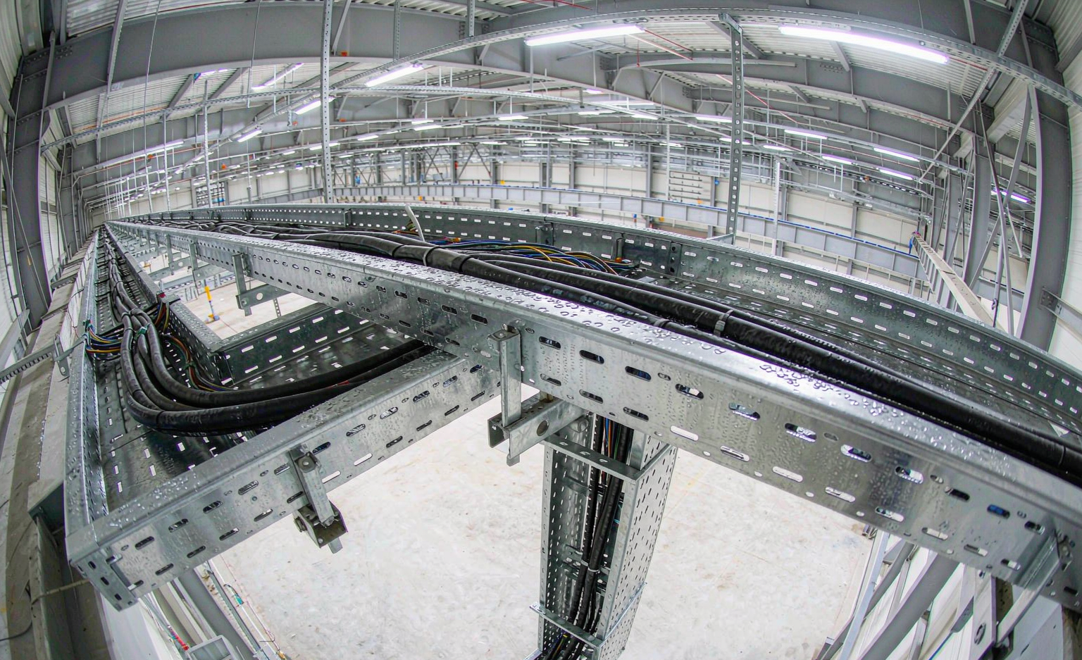 Cable trays routing power cables in an industrial facility